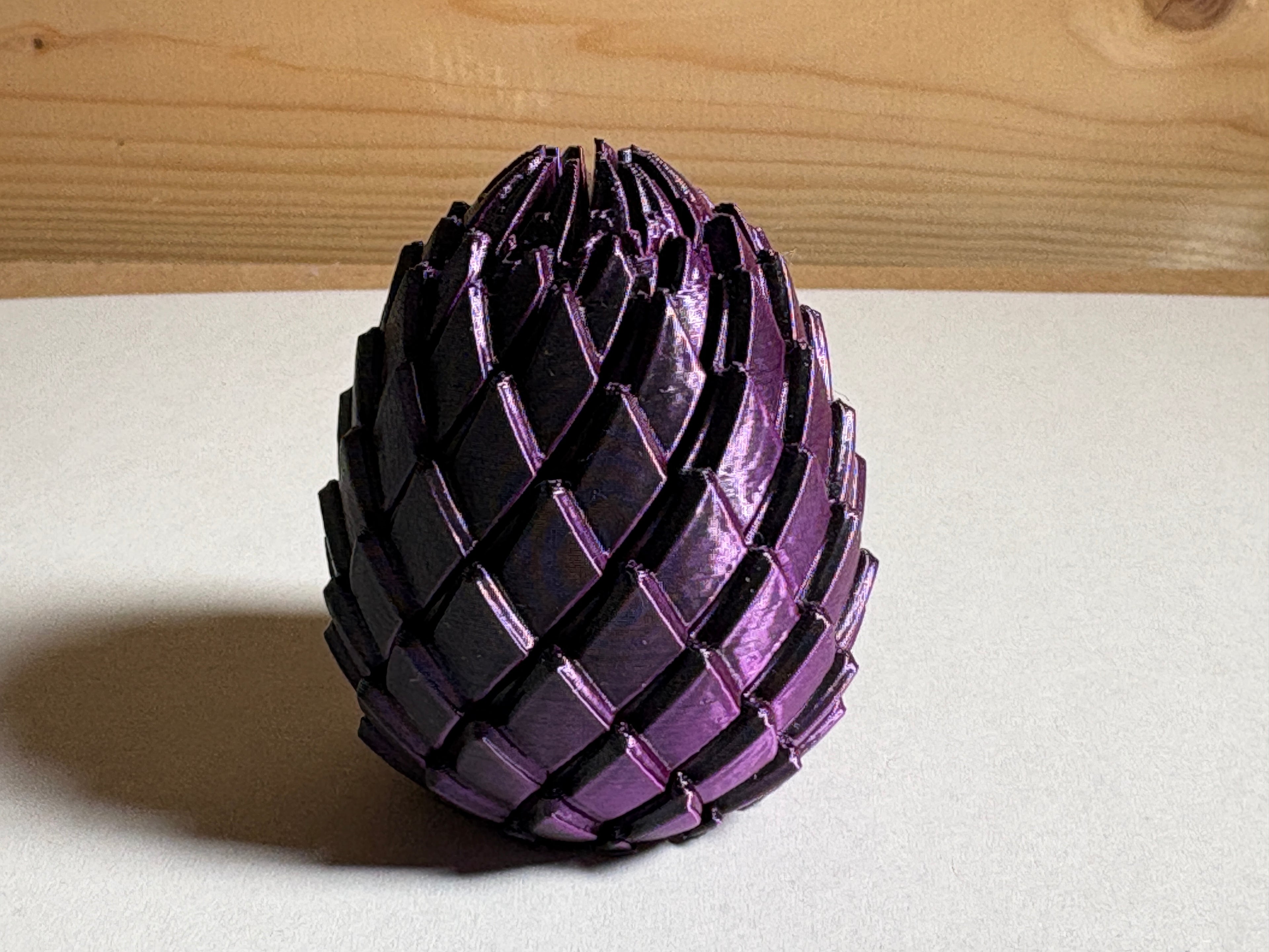 Purple and Black 3 Printed Dragon Egg on a white table 