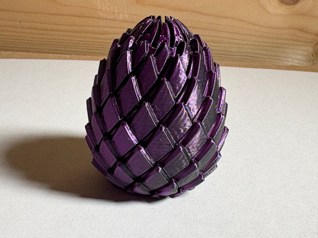A Purple and Black Fidget Dragon Egg